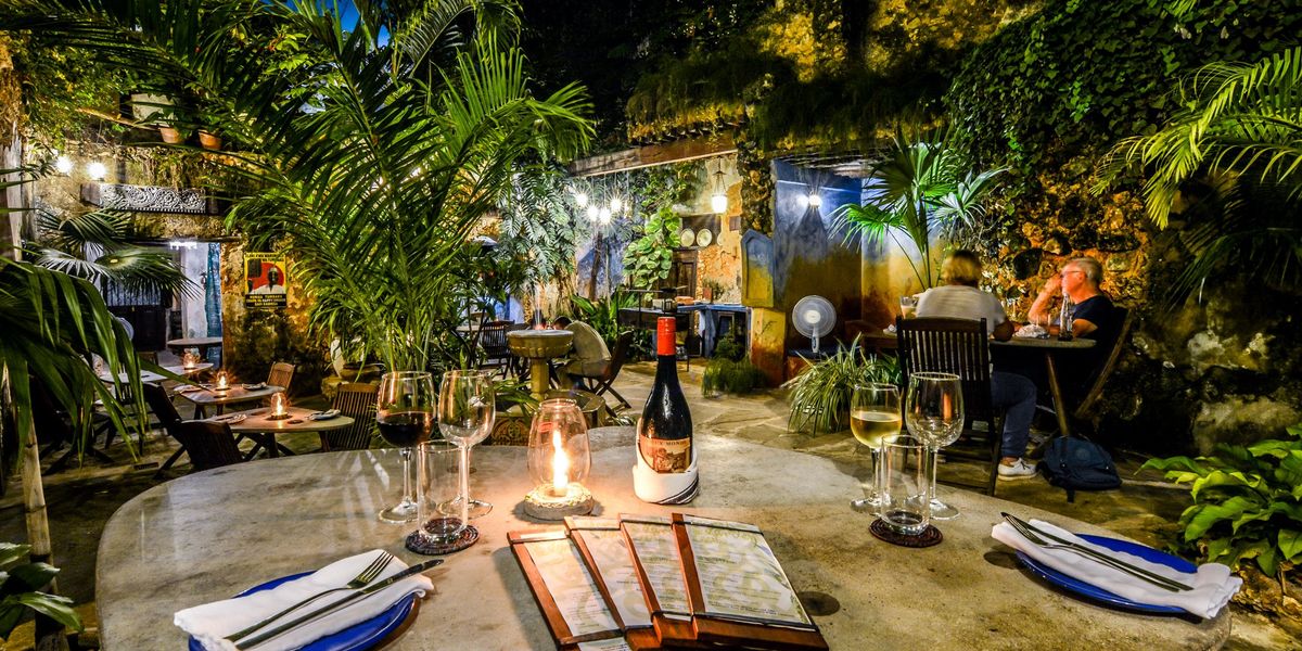Dinner table set with wine at night outside