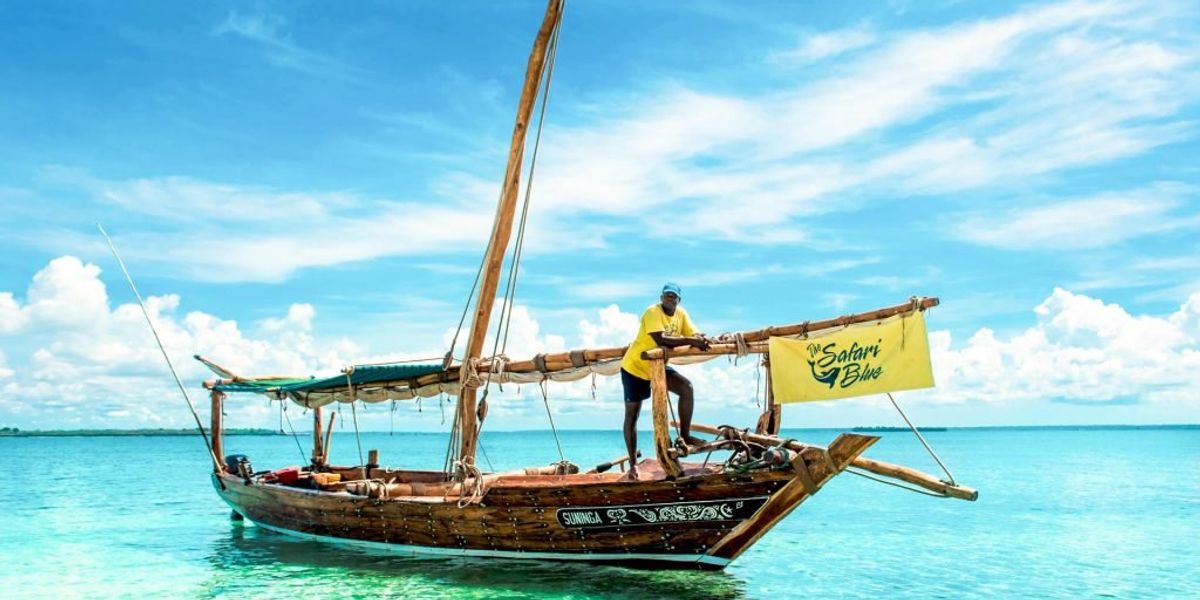 Wooden Dhow boat anchord at the shore with Captain